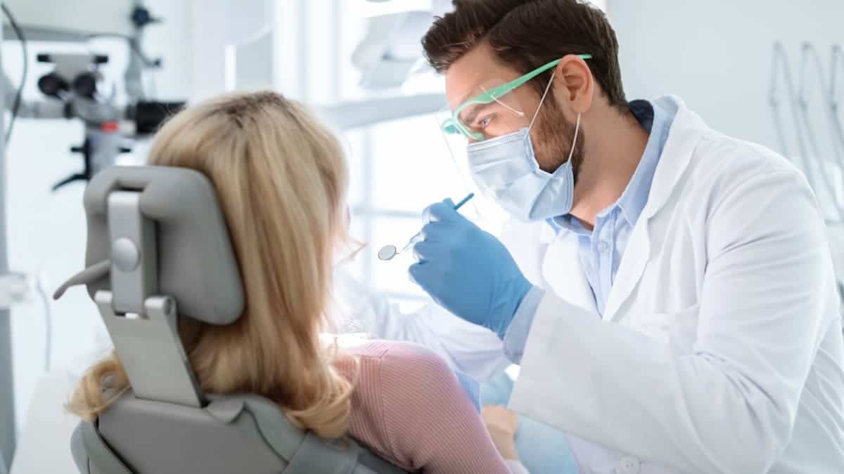 Patient receiving professional teeth whitening with a laser device Dundee